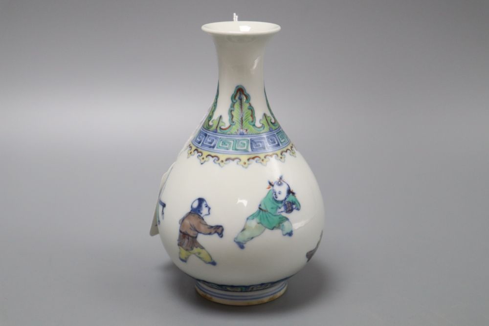 A Chinese doucai figurative bottle vase, bears Yongzheng mark, height 17cm